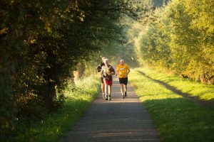 three old men running on a path